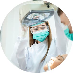 Dentist and assistant treating a patient