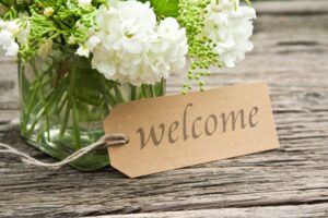 Flower vase with a welcome tag